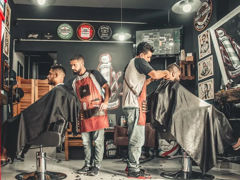 Barbers cutting hair in a modern Tanzanian barbershop